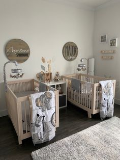 two baby cribs in a white nursery room