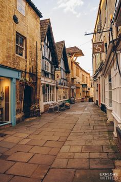 an empty street with tables and benches in the middle