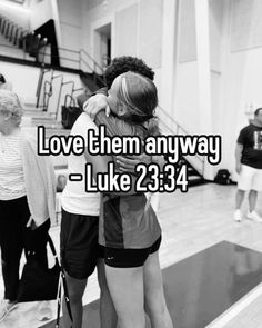 two people hugging each other in the middle of a gym floor with text that reads love them