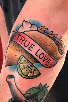 a taco tattoo with the words true love on it and a slice of lime