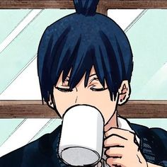 a man with black hair drinking from a cup