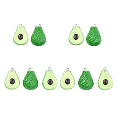 six pieces of green glittered avocado with black beads on each side and one piece