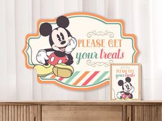 there is a sign that says please get your treats and mickey mouse on the wall