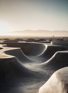 the skateboard park has many ramps for people to ride down it's slope