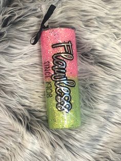 a pink and green can with the word princess on it sitting on a furry surface