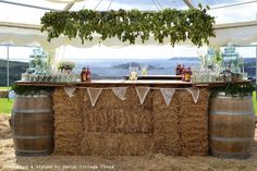 an outdoor bar set up with hay bales