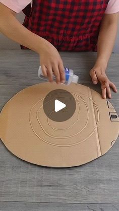 a woman is making a cardboard cutout on the floor