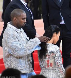 the man is cutting the woman's hair in front of some other people at an event