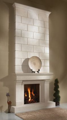 a living room with a fire place in the center and a bowl on top of it