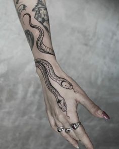 a woman's hand with a tattoo on it and an octopus in the middle