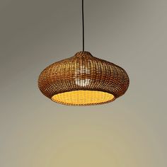 a light that is hanging from the ceiling in a room with gray walls and flooring