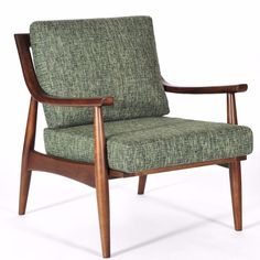 a green chair sitting on top of a white floor next to a wooden armrest