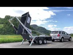 a truck pulling a large object on the back of it's trailer