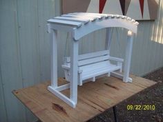 a white bench sitting on top of a wooden table