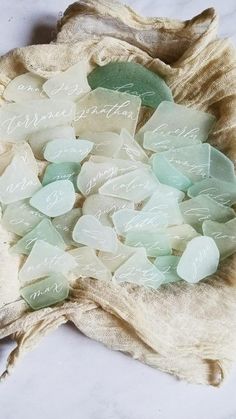 sea glass is on top of a cloth bag with the words, i love you