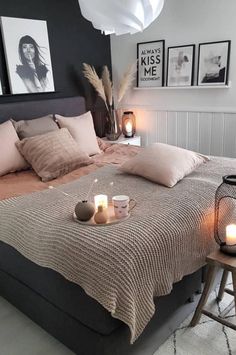 a bed with candles and pictures on the wall