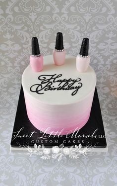 a birthday cake with pink and black frosting on it, decorated with three nail tips