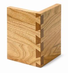 the corner of a wooden box with three sections cut out to look like an arrow