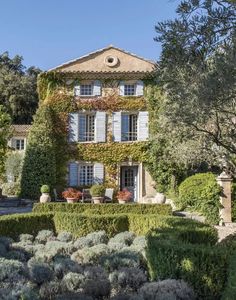 an old house covered in vines and flowers