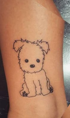 a small dog tattoo on the ankle