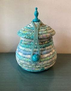 a stack of cloths sitting on top of a table next to a blue ball