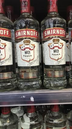 bottles of smirnoff vodka on display in a store