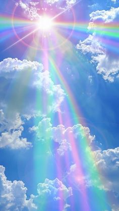 the sun is shining brightly in the blue sky with white clouds and bright rainbow colors