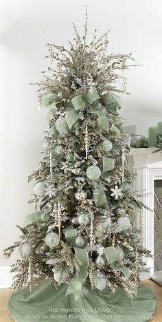 a decorated christmas tree with silver and white ornaments