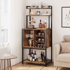 a living room filled with furniture and a wine rack next to a couch in front of a window