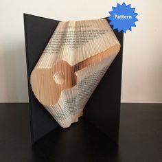 an origami book folded into the shape of a heart