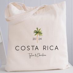 a tote bag with the name costa rica on it and a palm tree logo