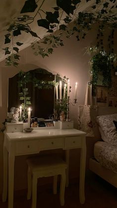 a bedroom with candles on the table and plants hanging from the ceiling