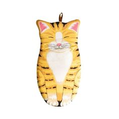 a yellow and white cat ornament hanging on a wall