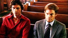 two men sitting next to each other in front of pews with one man wearing a red shirt and tie