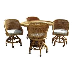 three wicker chairs and a table on wheels