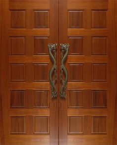 two wooden doors with metal handles on each side and an ornate design at the top