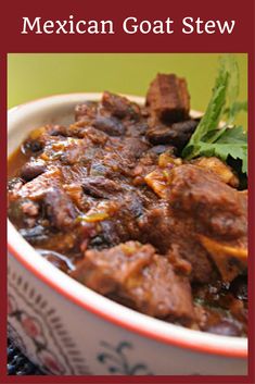 a close up of a bowl of food with meat and vegetables in it on a table