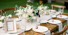 the table is set with plates and place settings