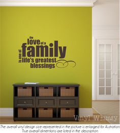 a wall decal with the words love and family on it in black against a green background