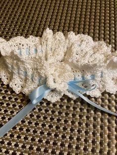 Beautiful crocheted wedding garter in fine silk yarn adjustable by blue woven ribbon gathered around to leg size.  Accented with a pretty crocheted flower and pearl.  Great keepsake to save from that special day.  Made to order if not in stock. Crocheted Flower, Woven Ribbon, Wedding Garter, Silk Yarn, Fine Yarn, Crochet Art, Gift List, Blue Satin, Fiber Art