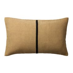 a beige pillow with black piping on the side