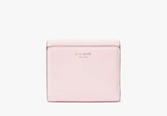 Say hello to our new icon. Made from smooth leather the Dakota features our signature K hardware for a bold modern look. Settle your tab in style with this compact bifold flap wallet. | Kate Spade Dakota Bifold Flap Wallet, Shimmer Pink Cheap Kate Spade Wallets With Card Slots, Luxury Rectangular Kate Spade Wallet, Affordable Elegant Kate Spade Wallets, Cute Pink Wallet, Light Pink Wallet, Kate Spade Wallet Pink, Small Wallets For Women, Pink Era, Pink Wallet