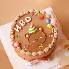 a birthday cake with a teddy bear on it