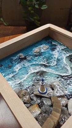 a wooden box filled with rocks and water