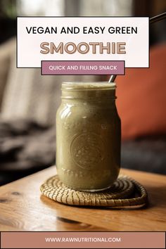 a jar filled with smoothie sitting on top of a wooden table