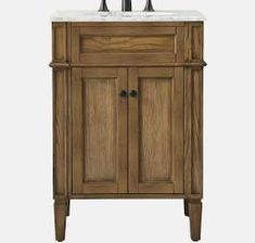 a bathroom vanity with marble top and two faucets