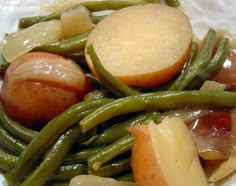 potatoes, green beans and onions on a white plate