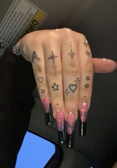 a woman's hand with tattoos on it