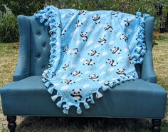 a blue chair with a panda bear blanket on it