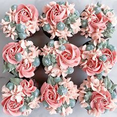 cupcakes with pink frosting and green leaves are arranged in the shape of a flower